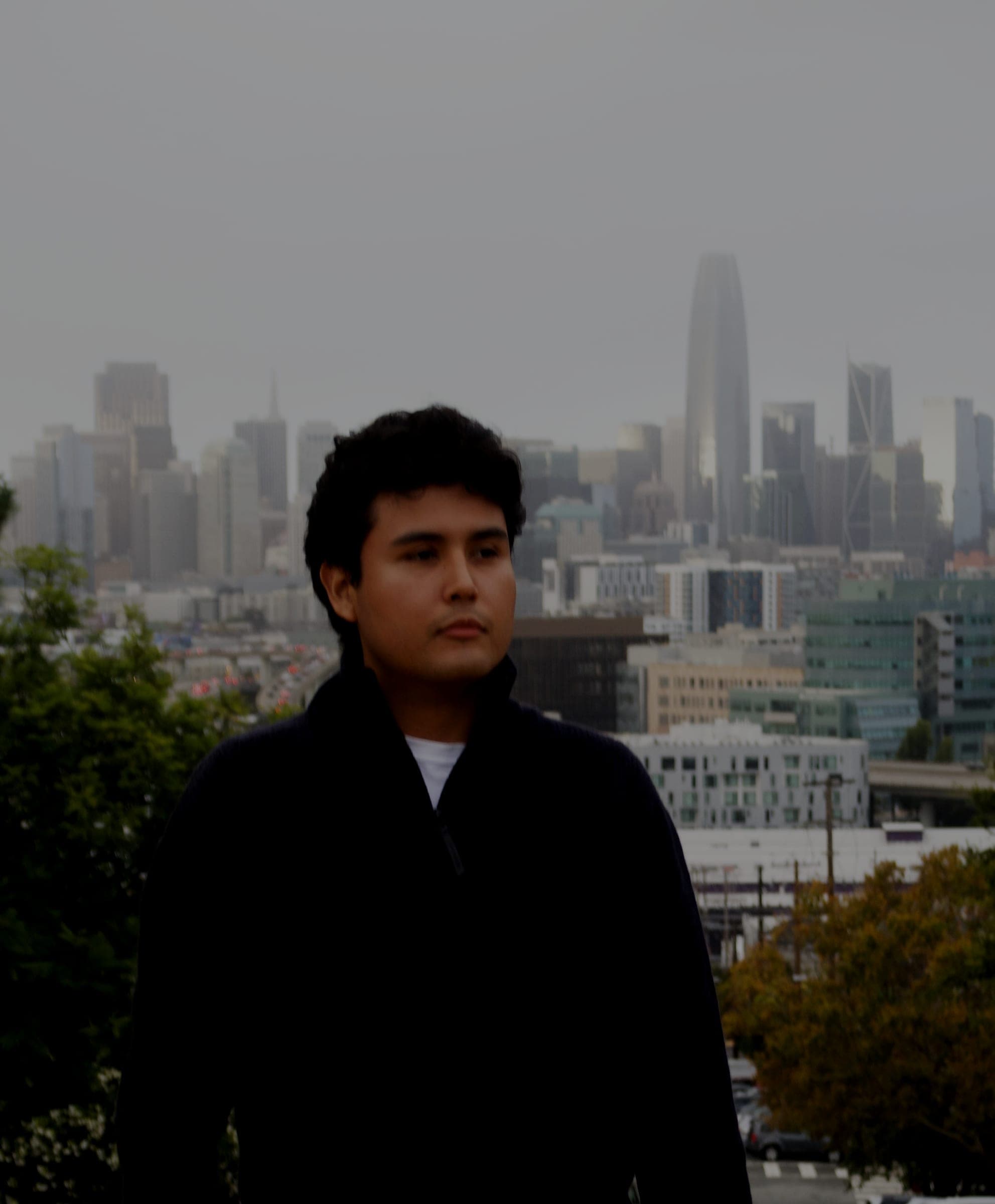 Jeffrey Escobar in San Francisco with the downtown skyline and Salesforce Tower behind him